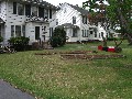 May 18: front yard with three mulch beds. The two big ones are for tobacco, the fenced one has wildflowers already sprouting.